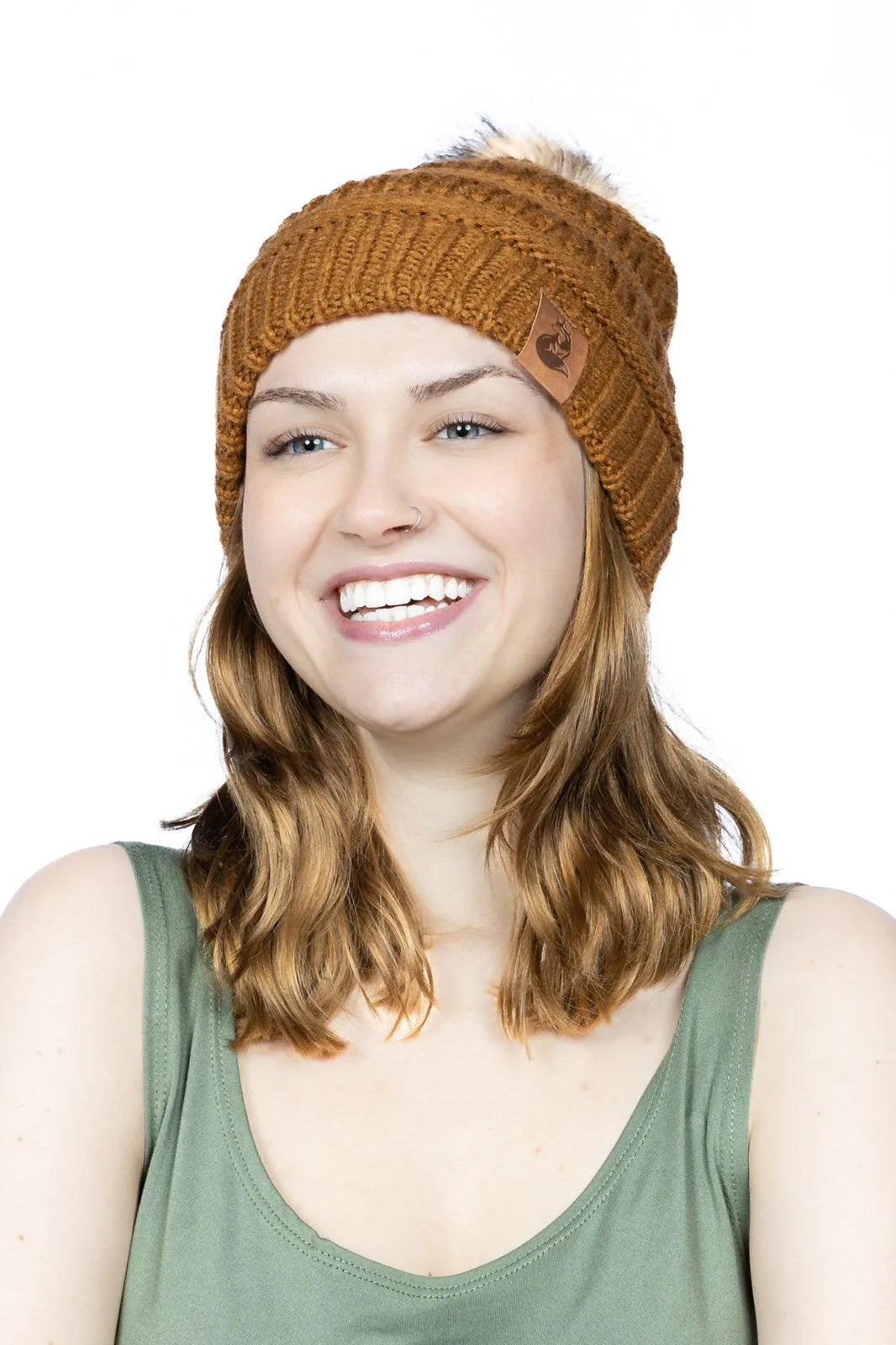 Smiling woman wearing Sequoia ribbed knit beanie with pom