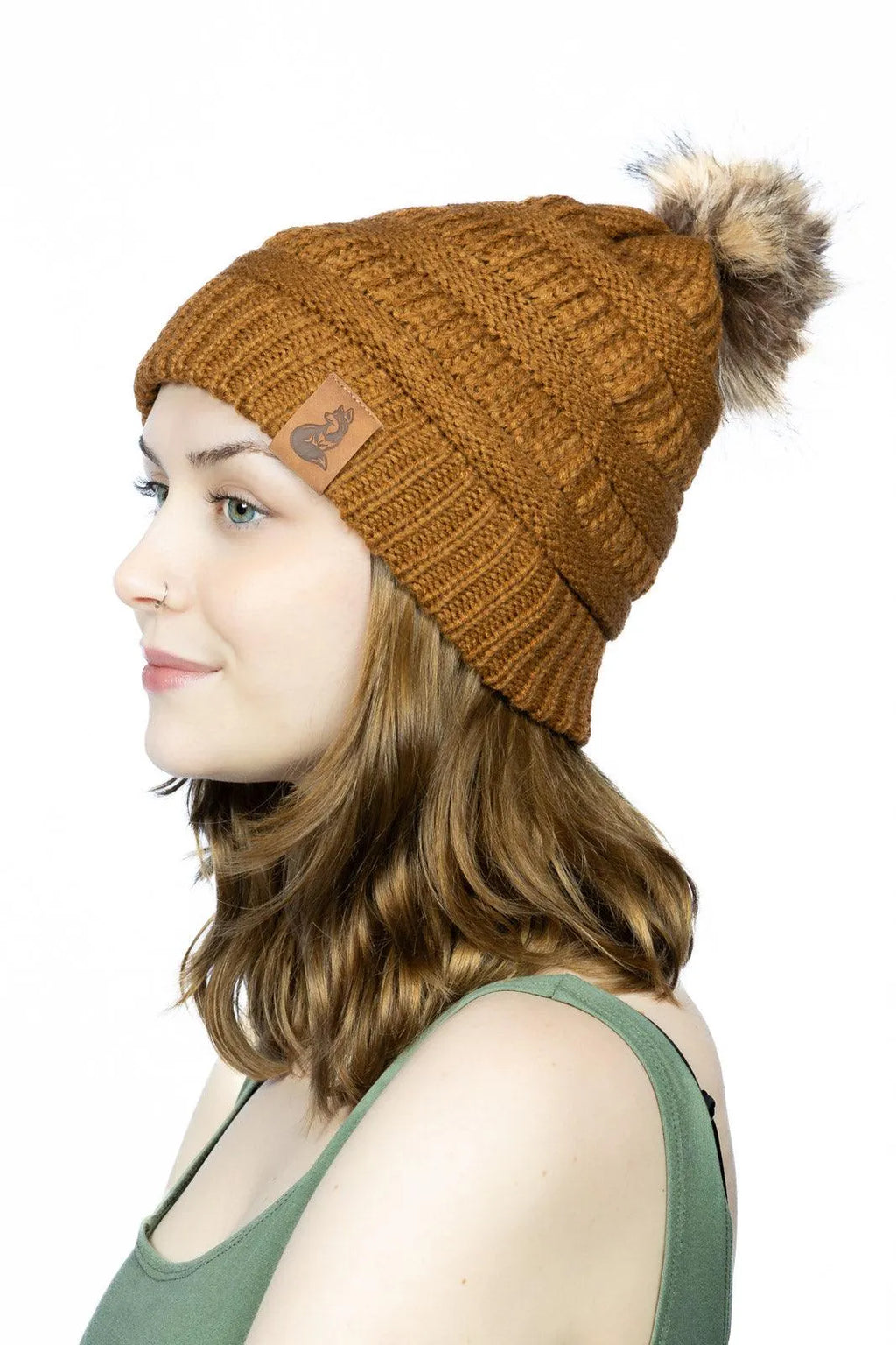 Side view of woman wearing Sequoia ribbed knit beanie with pom outdoors